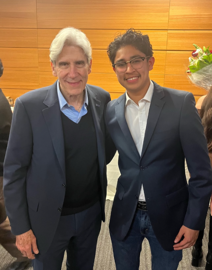 Writer Andrew Campuzano stands next to Chancellor Julio Frenk Mora.